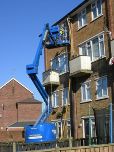 Cavity wall insulation being installed in block of flats 